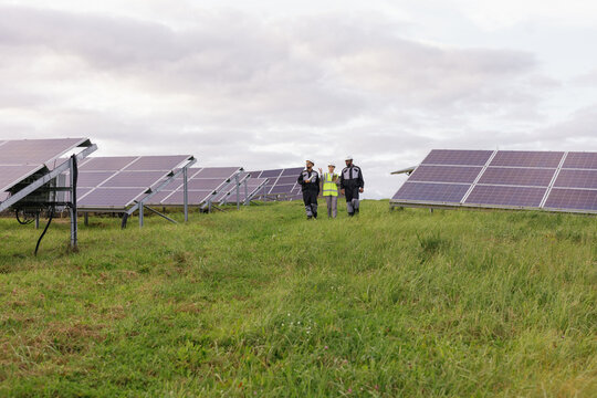 Group foreign workers inspection solar panels multicultural 