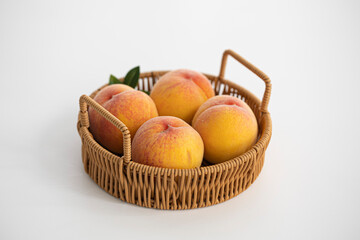 yellow peaches in a basket