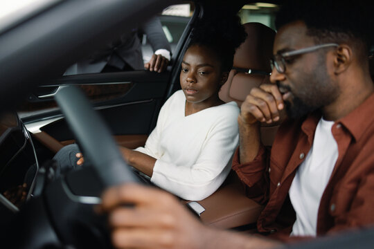 Young customers cheking car together automotive industry