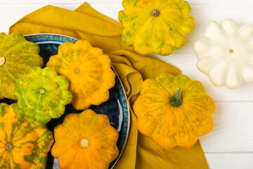 Pattypan zucchini on a textured kitchen table. squash. Fresh organic pattypan squashes on...