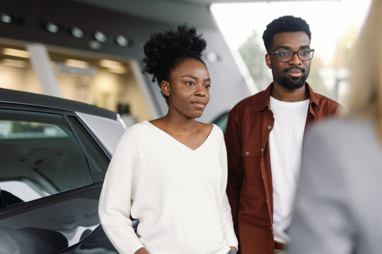 A concentrated couple automotive business car dealer