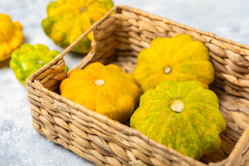 Pattypan zucchini on a textured kitchen table. squash. Fresh organic pattypan squashes on...