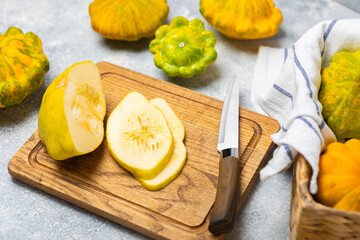 Pattypan zucchini on a textured kitchen table. squash. Fresh organic pattypan squashes on background. Vegan. Farmer's Market. Patisson. Space for text. Copy space.