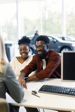 Black smiling couple customers seals deal consultant office 