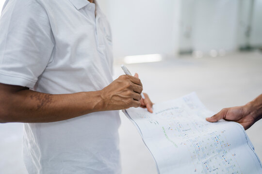 Anonymous man checking papers in employee hand