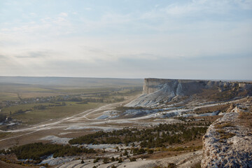 Scenic valley view with majestic mountain and plane flying overhead in relaxing nature landscape for travel and adventure concept