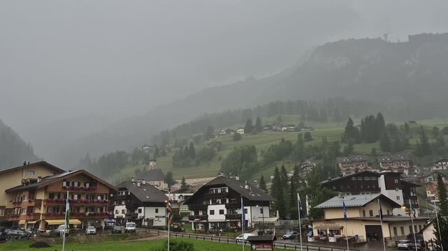 Clouds and rain above Campitello di Fassa and Sassolungo mountain - Val di Fassa - Italy