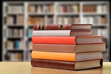 pile of reading books on table in library, education