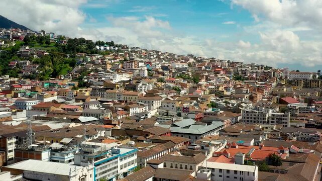 Drone shot of Quito city brick roofs colonial architecture El Panecillo hill.