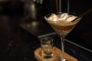 Homemade dessert ice cream with coffee in glass on wooden tray.