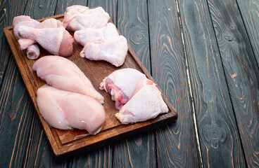 Raw mixed chicken meat parts  for cooking on rustic background