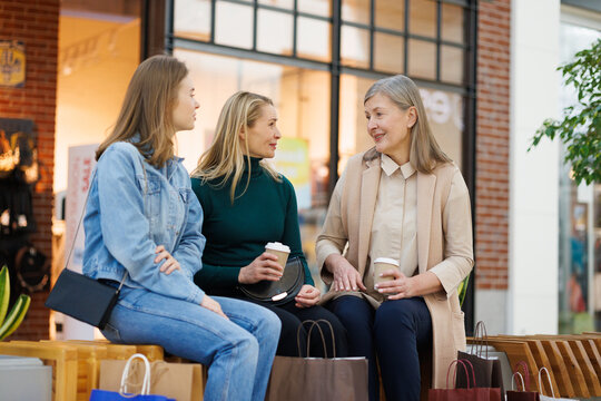 Grandmother, mother with coffee and daughter in mall in free time
