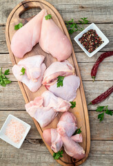 Raw mixed chicken meat parts  for cooking on rustic background © whitestorm