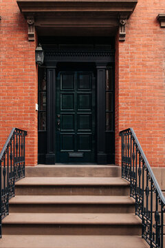 Black Door with Iron Railings