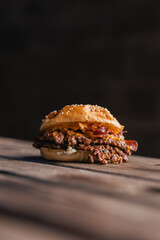 Beef burger with cheese and a sesame seed bun, gourmet hamburger, fast food and takeaway