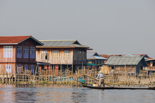 Wooden Houses on Stilts with Boatman