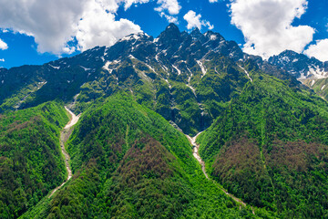 Naklejka premium High picturesque green mountains with the remains of melting snow in the mountains of the North Caucasus. Russia