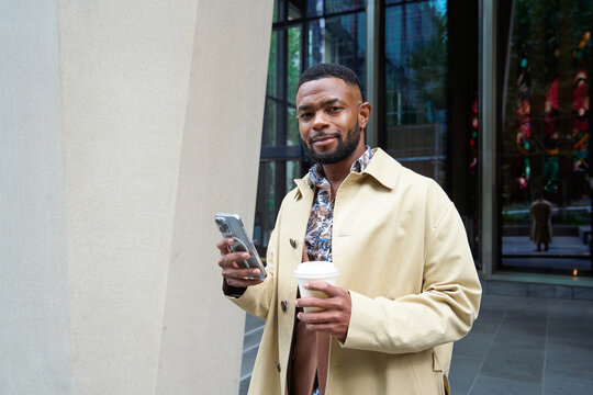 A business man in Collins Street Melbourne using a phone