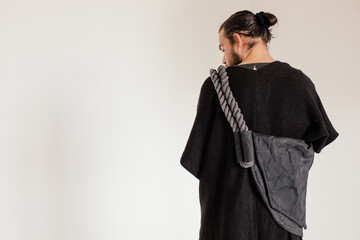 fashion portrait of brunette man with big bag