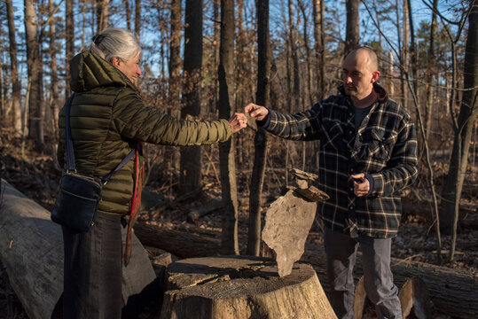 Collaborative moment mother and son stone balancing