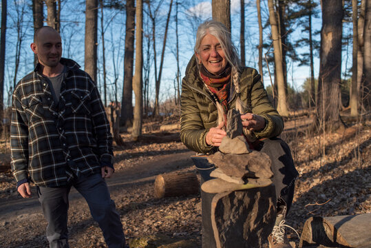 Mother and son playing stone balancing