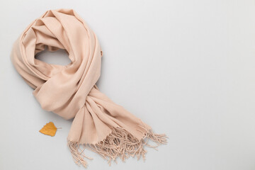 Stylish scarf on color background, top view