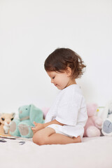 happy cute little baby girl in white t-shirt playing in her room