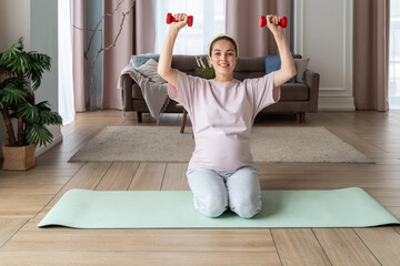 Pregnant Woman Exercising with Dumbbells at Home