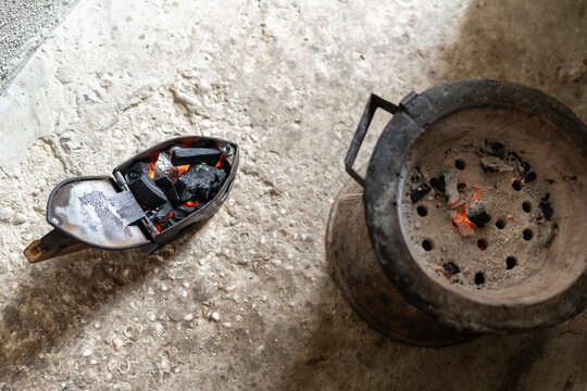 Traditional charcoal iron heating on a brasero in senegal, africa
