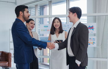 Portrait business teamwork woman and man Asian standing on wall white board looking smile shake hand within the agreement plan new job project ready for happy working online sale inside home office