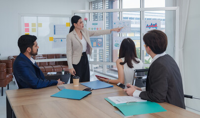 Fototapeta premium Portrait business woman asian stand presentation holding pen and looking creative write note plan maketing new idea project ready happy working online sale and team inside home office with intention