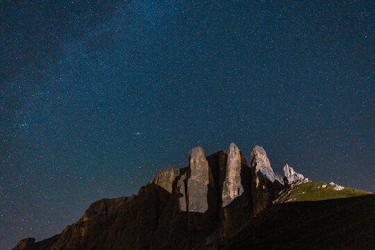 Starry sky above pinnacle mountain in Dolomites