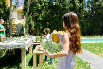 family Setting Up Outdoor Table for Gathering 