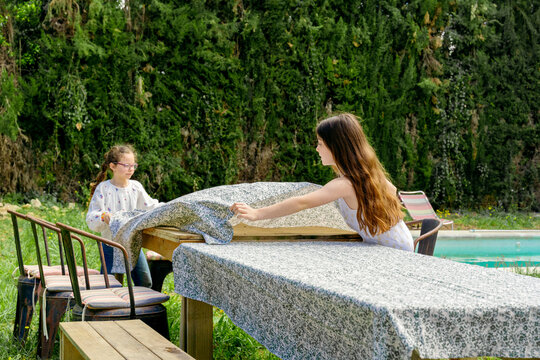 Girls Setting Up Outdoor Table for Picnic