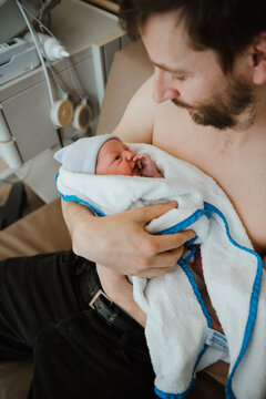 Parent's first embrace with baby at clinic