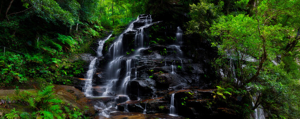 Stunning ribbon waterfall cascade in lush green forest
