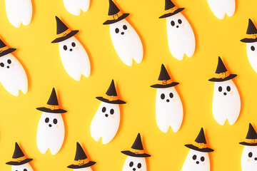 Halloween pattern made of white ghosts with witch hat on yellow background Cartoon style