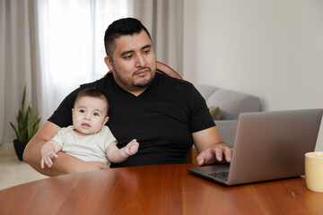 Hispanic man works from home with laptop- Millennial entrepreneur in his home office - man working online - young man studying from home - homeschooling