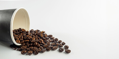 Roasted Arabica coffee beans, ready to make coffee that people like to drink. Placed in a Black coffee cup paper on the background. Looks beautiful and appetizing. Drink.