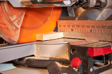 man sawing wood on a circular saw close-up