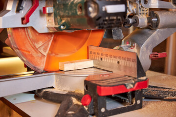 man sawing wood on a circular saw close-up