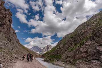 Beautiful mountain scenery. River, valley, snow, blue sky, white clouds. In-depth trip on the Sonamarg Hill Trek in Jammu and Kashmir, India