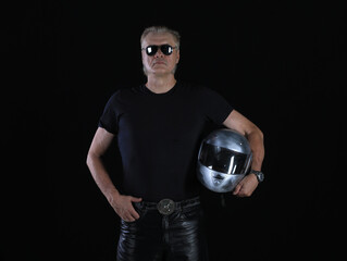portrait of biker in silver helmet on black background