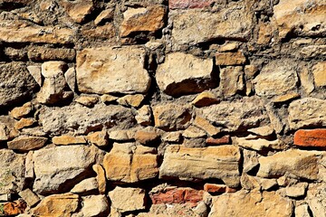 Background, texture wall of an old fortress made of processed light stones