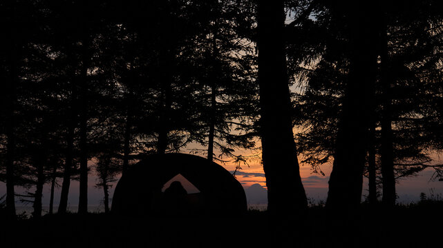 Sunset tent forest and ocean 