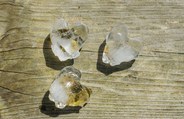 heart shaped ice cubes on wooden background top view . High quality photo