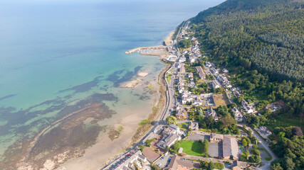 Aerial view on houses on coast of see in Newcastle, Northern Ireland. Coastal town, Drone photo