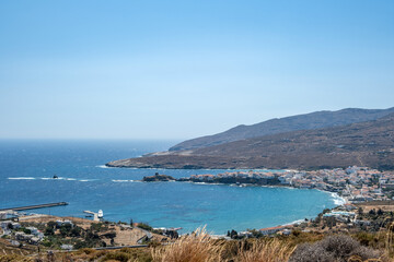 Fototapeta na wymiar Andros island, Chora, Cyclades Greece. View of white town buildings, the bay and the cape