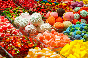 Assortment of various colorful jelly candies at a sweet stall in a market in Barcelona, Spain