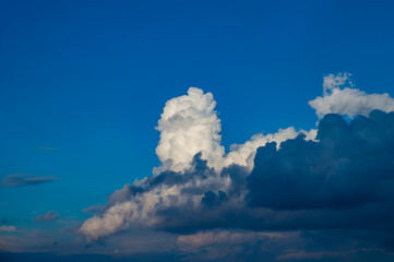 Thunderstorm cumulus clouds on blue sky. Cloudy weather. White cumulus clouds. Skies before...